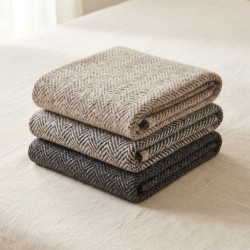 Herringbone Wool Throw in undyed wool, folded to show the cream and charcoal herringbone weave
