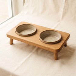 Raised Oak Double Feeder: an oiled solid oak stand holding two stoneware bowls